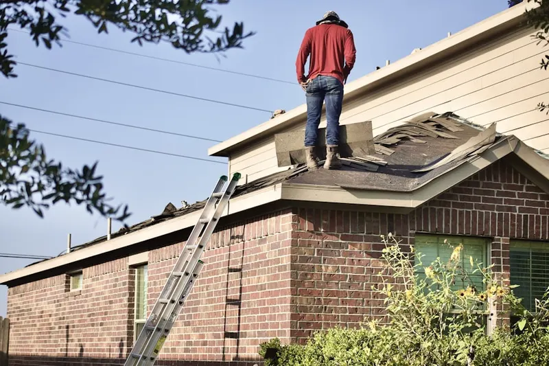 Professional roofer working on a residential roof in North Harbor View